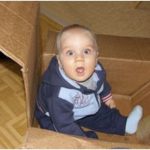 child in a cardboard box
